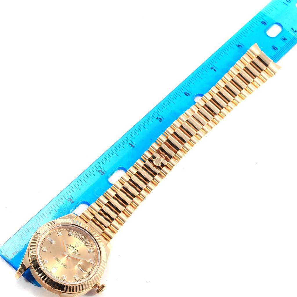 The image shows a Rolex President 218238 Men's Yellow Gold Champagne Dial 218238 Men's Yellow Gold Champagne Dial model watch laid flat next to a blue ruler, displaying the watch face and entire bracelet.