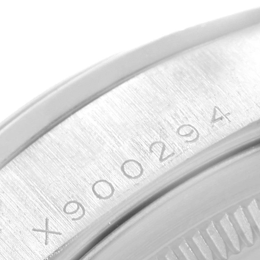 The image shows a close-up of the serial number engraving and part of the bezel on a Rolex President 18206 Men's Platinum Blue Dial 18206 Men's Platinum Blue Dial model.