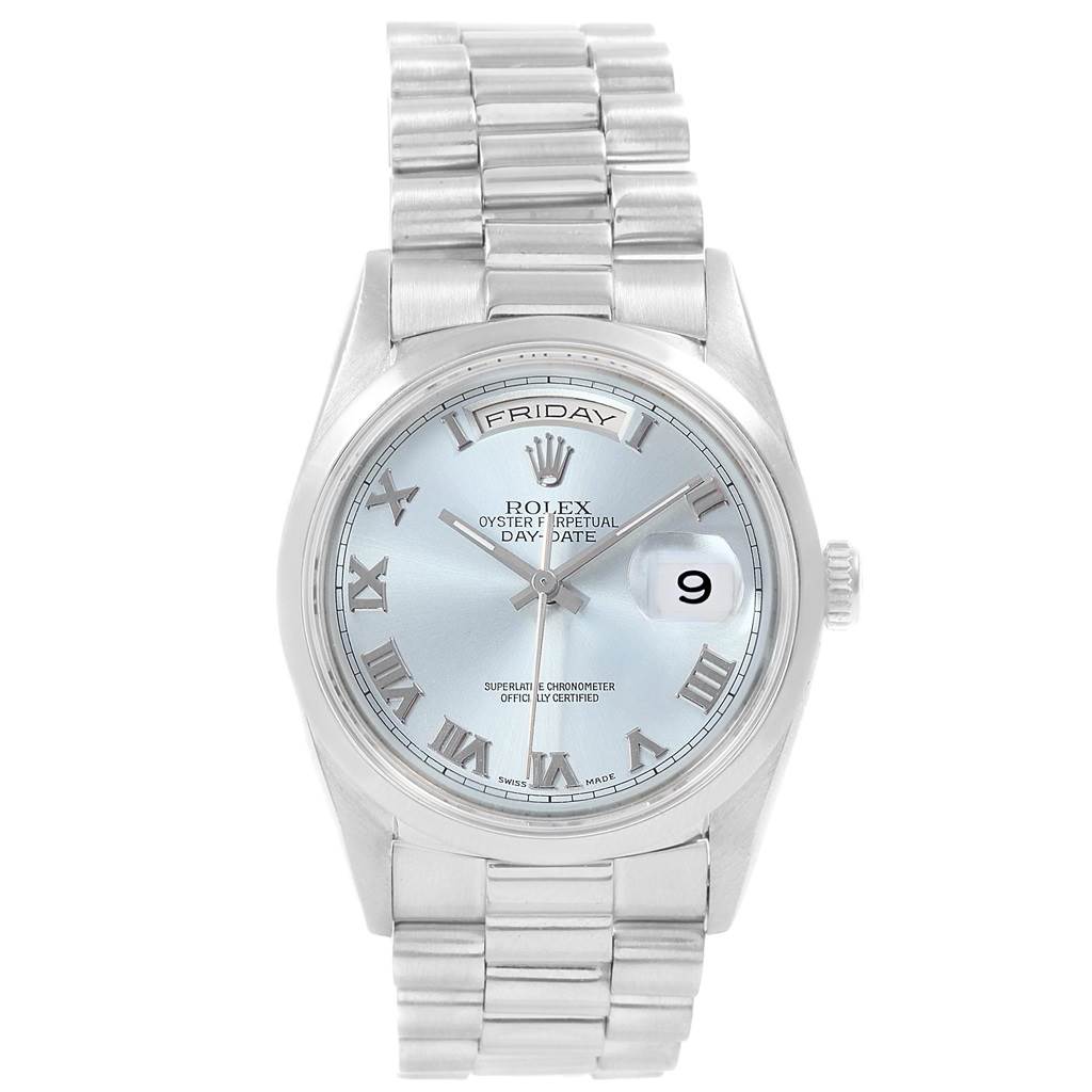 The image shows a Rolex President 18206 Men's Platinum Blue Dial 18206 Men's Platinum Blue Dial model watch, featuring a silver dial, Roman numerals, and a metal bracelet.