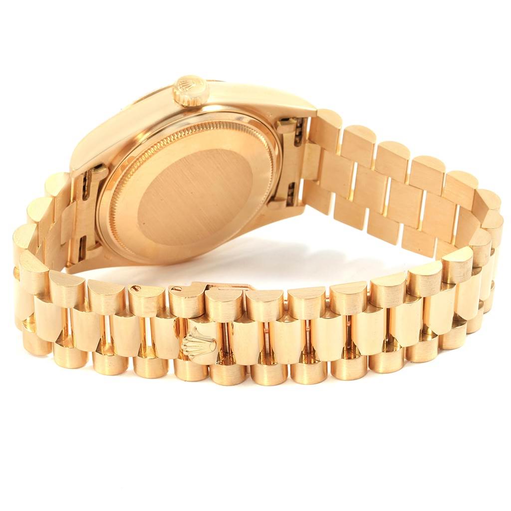 The image shows the back and bracelet of a Rolex President 18038 Men's Yellow Gold Champagne Dial 18038 Men's Yellow Gold Champagne Dial model watch, highlighting its gold links and case back.