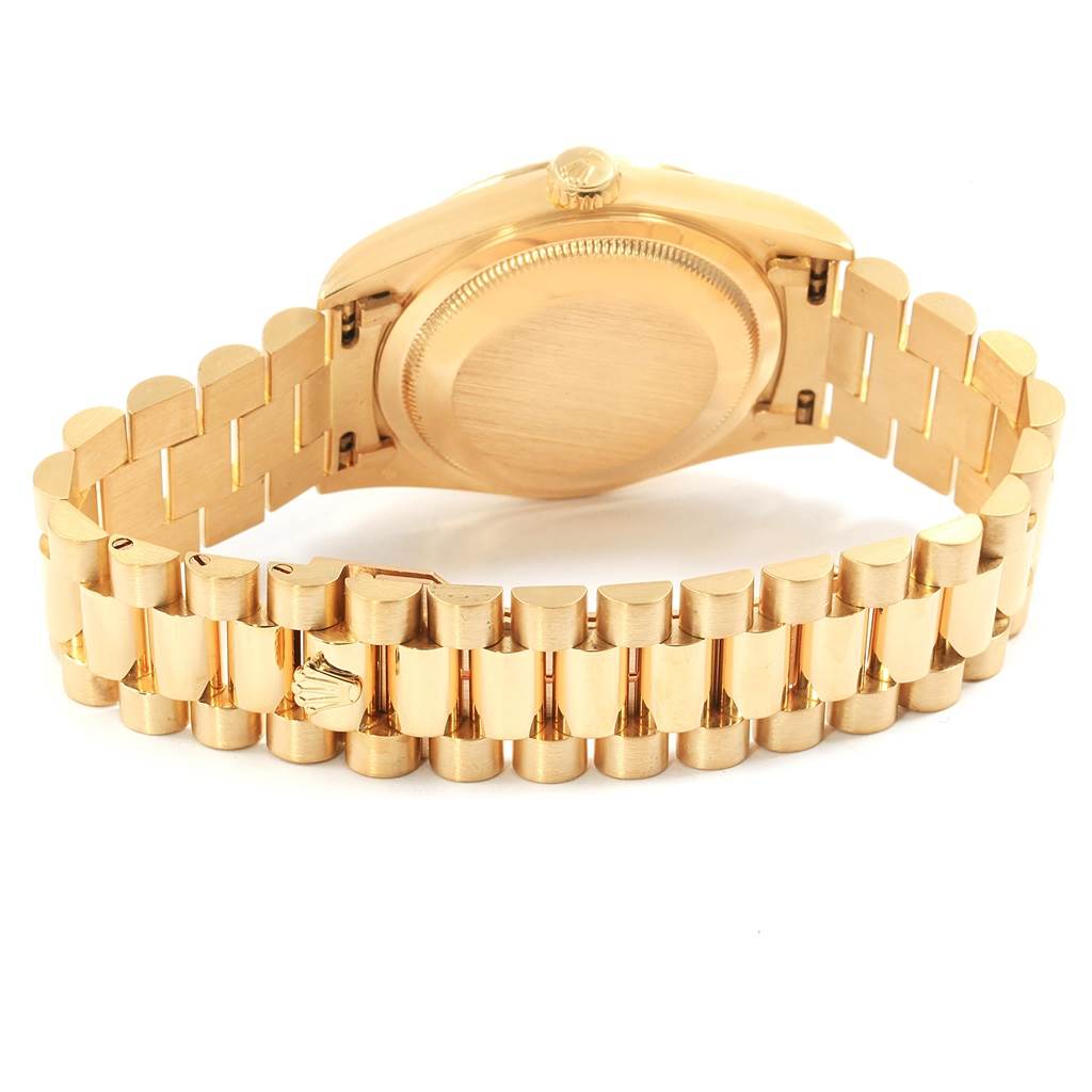 This is a rear view of the Rolex President 18238 Men's Yellow Gold Black Dial 18238 Men's Yellow Gold Black Dial model watch showing its back case and gold bracelet.