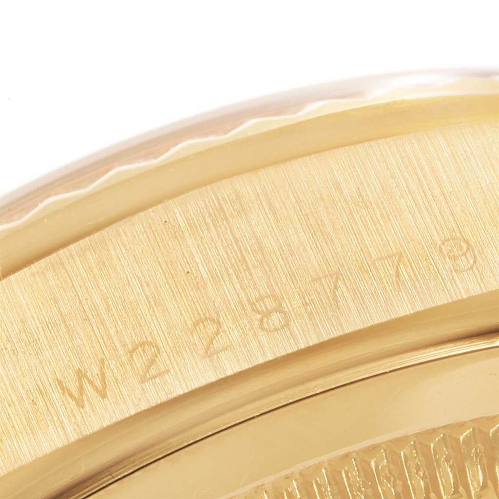 This is a close-up of the serial number engraving on the case edge of a Rolex President 18238 Men's Yellow Gold Black Dial 18238 Men's Yellow Gold Black Dial model watch.