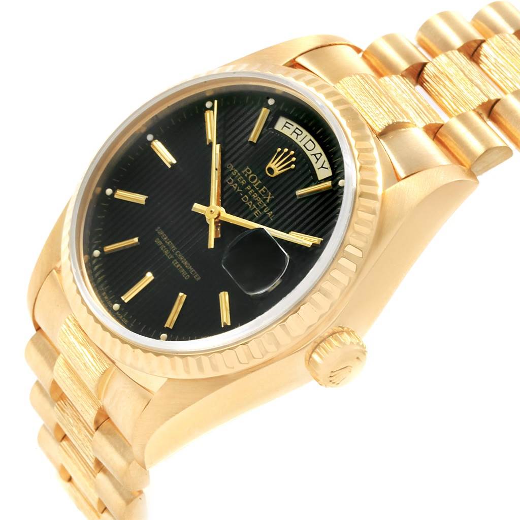 The image shows an angled view of a gold Rolex President 18048 Men's Yellow Gold Black Dial 18048 Men's Yellow Gold Black Dial model watch, highlighting its black dial, day/date display, crown, and bracelet.