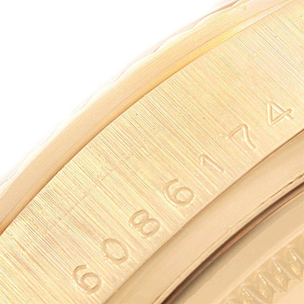 This close-up image shows the outer rim and case back of the Rolex President 18048 Men's Yellow Gold Black Dial 18048 Men's Yellow Gold Black Dial model, highlighting the engraving details.