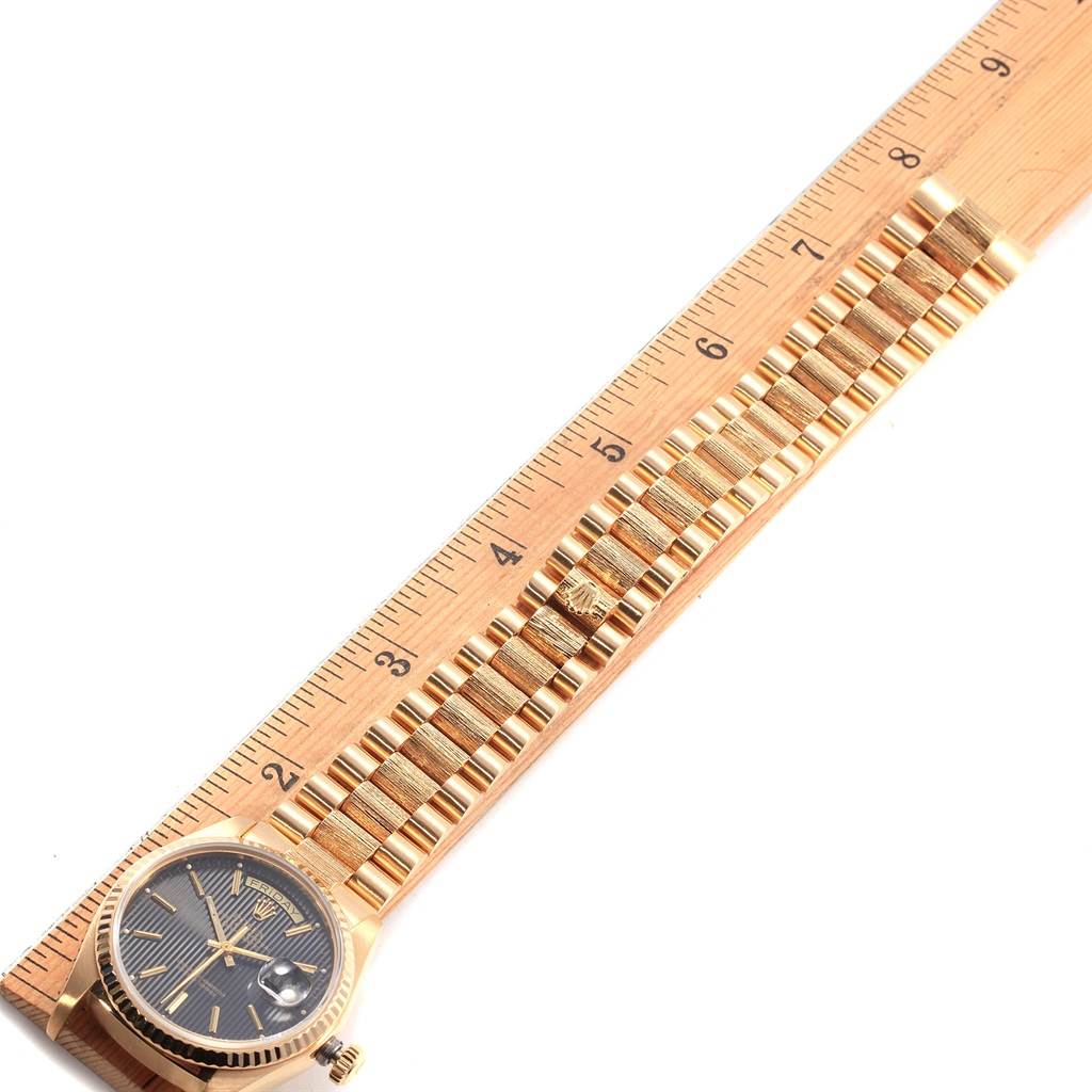 The image shows a Rolex President 18048 Men's Yellow Gold Black Dial 18048 Men's Yellow Gold Black Dial model watch laid out on a ruler, highlighting the face and bracelet in a top-down view.