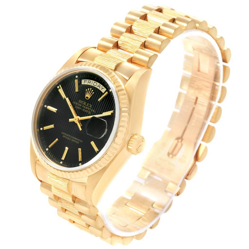 The Rolex President 18048 Men's Yellow Gold Black Dial 18048 Men's Yellow Gold Black Dial model watch is shown at an angle displaying the gold bracelet, black dial, and side crown.