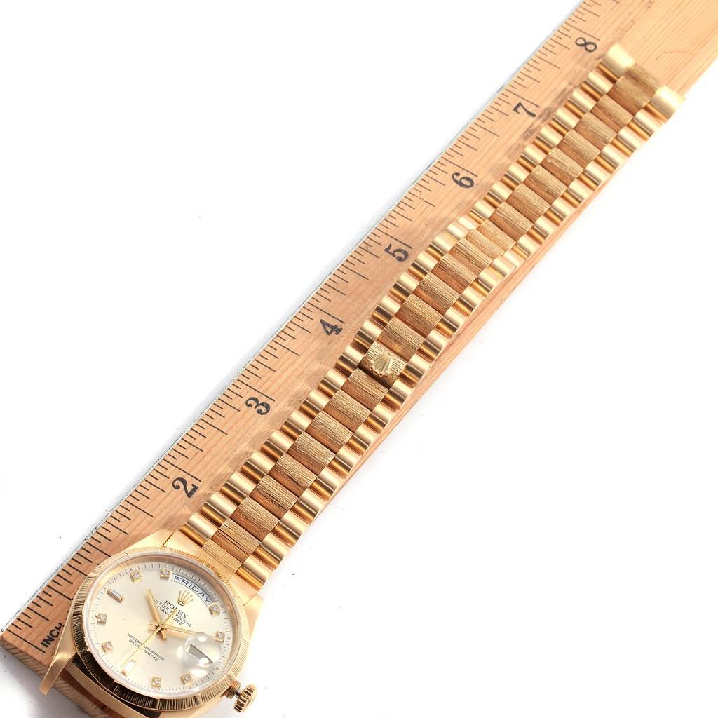 The image shows a Rolex President 18248 Men's Yellow Gold Silver Dial 18248 Men's Yellow Gold Silver Dial model watch laid next to a ruler, displaying the face and bracelet.