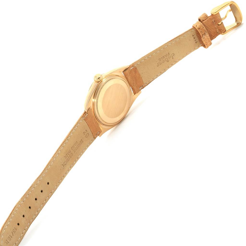 The image shows the back view of a Rolex President 1803 Men's Yellow Gold Champagne Dial 1803 Men's Yellow Gold Champagne Dial model watch, including its caseback, crown, and leather strap with a buckle.