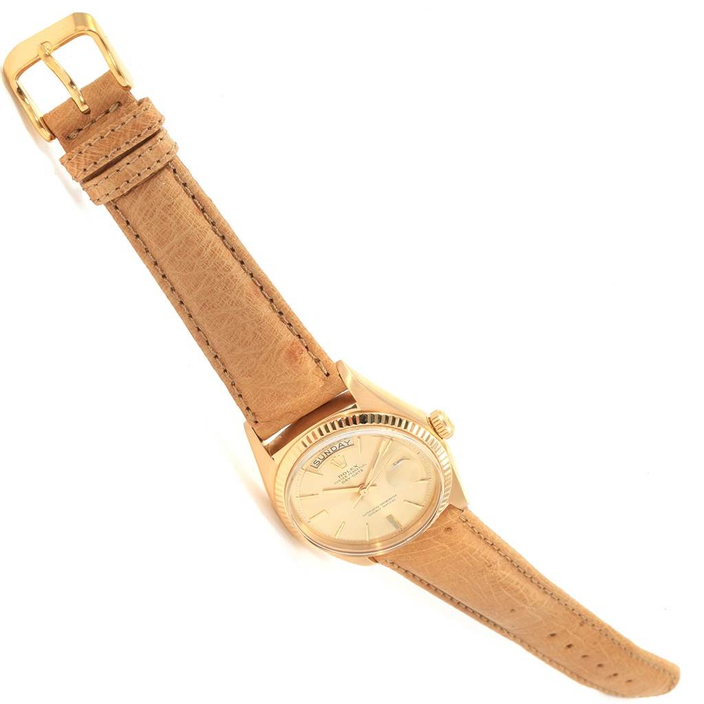 The Rolex President 1803 Men's Yellow Gold Champagne Dial 1803 Men's Yellow Gold Champagne Dial model watch is shown at an oblique angle, displaying its dial, bezel, crown, and leather strap.