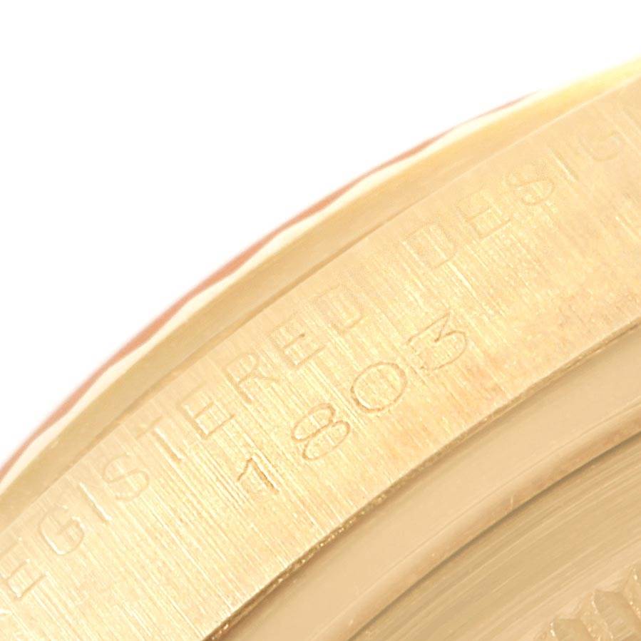 This close-up shows the engraved text on the bezel of a Rolex President 1803 Men's Yellow Gold Champagne Dial 1803 Men's Yellow Gold Champagne Dial model watch.