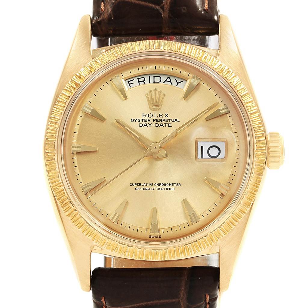 The image shows a Rolex President 1807 Men
s Yellow Gold Champagne Dial 1807 Men
s Yellow Gold Champagne Dial model watch face with a gold bezel, day and date displays, and leather strap from a frontal angle.