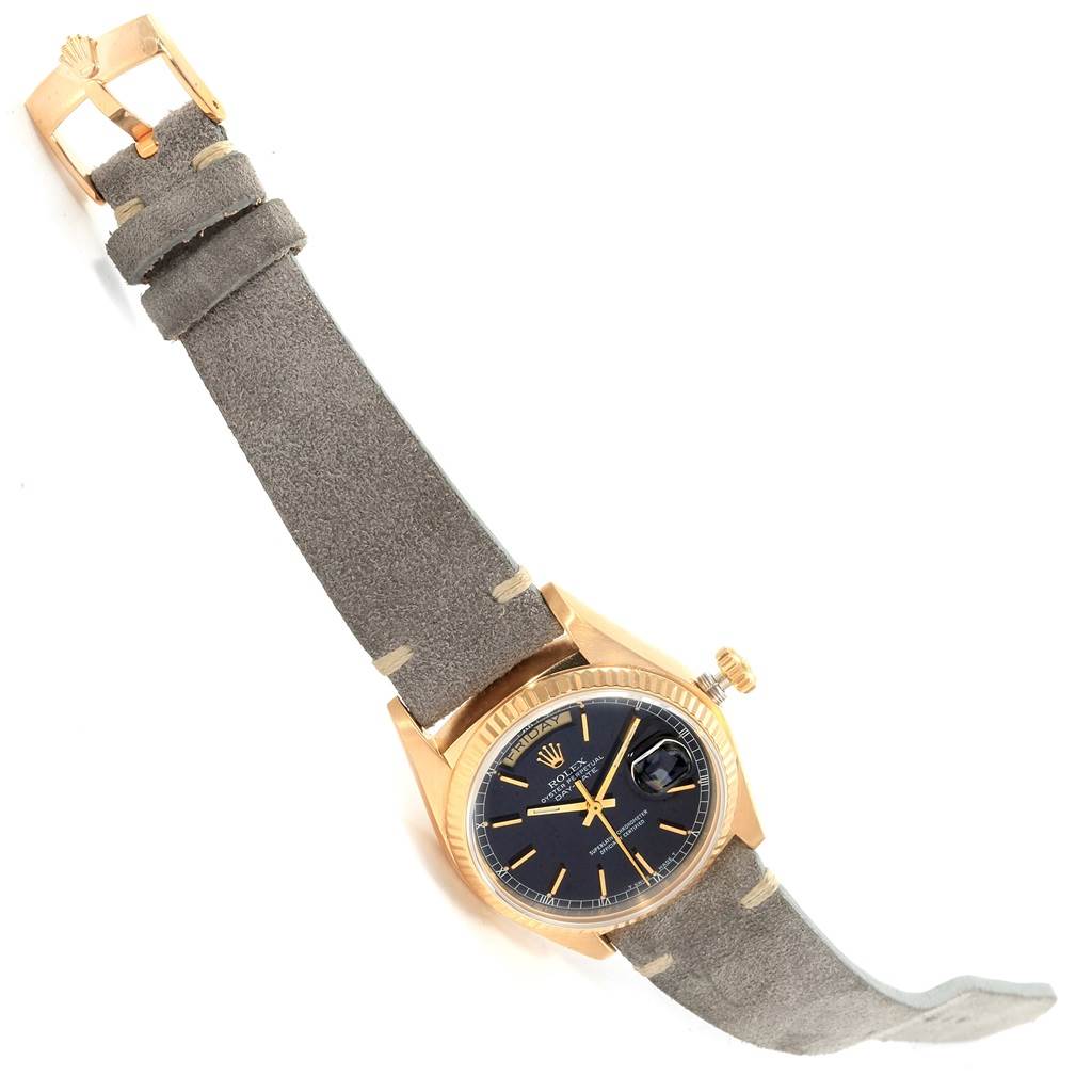 The image shows a Rolex President 18078 Men
s Yellow Gold Black Dial 18078 Men
s Yellow Gold Black Dial model watch angled diagonally with its face, crown, and strap clearly visible.