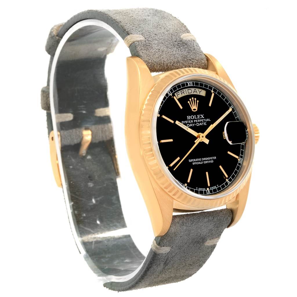 The image shows a side-angle view of a Rolex President 18078 Men
s Yellow Gold Black Dial 18078 Men
s Yellow Gold Black Dial model watch, highlighting its black dial, gold case, and gray strap.