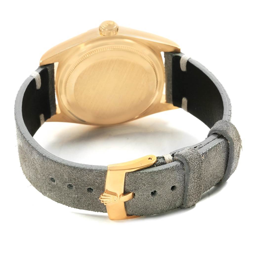 This image shows the back case and leather strap of a Rolex President 18078 Men
s Yellow Gold Black Dial 18078 Men
s Yellow Gold Black Dial model watch.