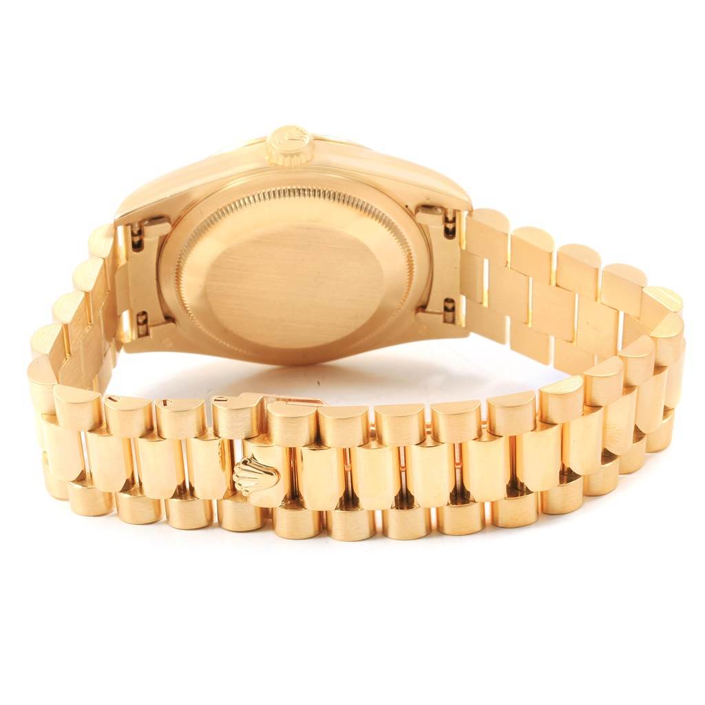 This is a rear view of a Rolex President 18238 Men
s Yellow Gold White Dial 18238 Men
s Yellow Gold White Dial model watch, showing its case back, crown, and part of its gold bracelet.