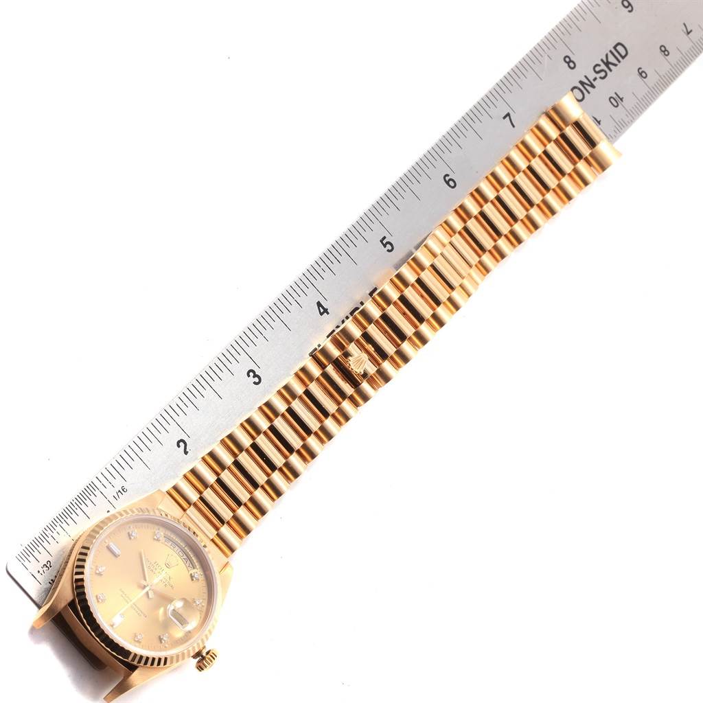 The image shows the Rolex President 18238 Men
s Yellow Gold Champagne Dial 18238 Men
s Yellow Gold Champagne Dial model watch laid flat with a ruler, displaying the watch face and entire bracelet.