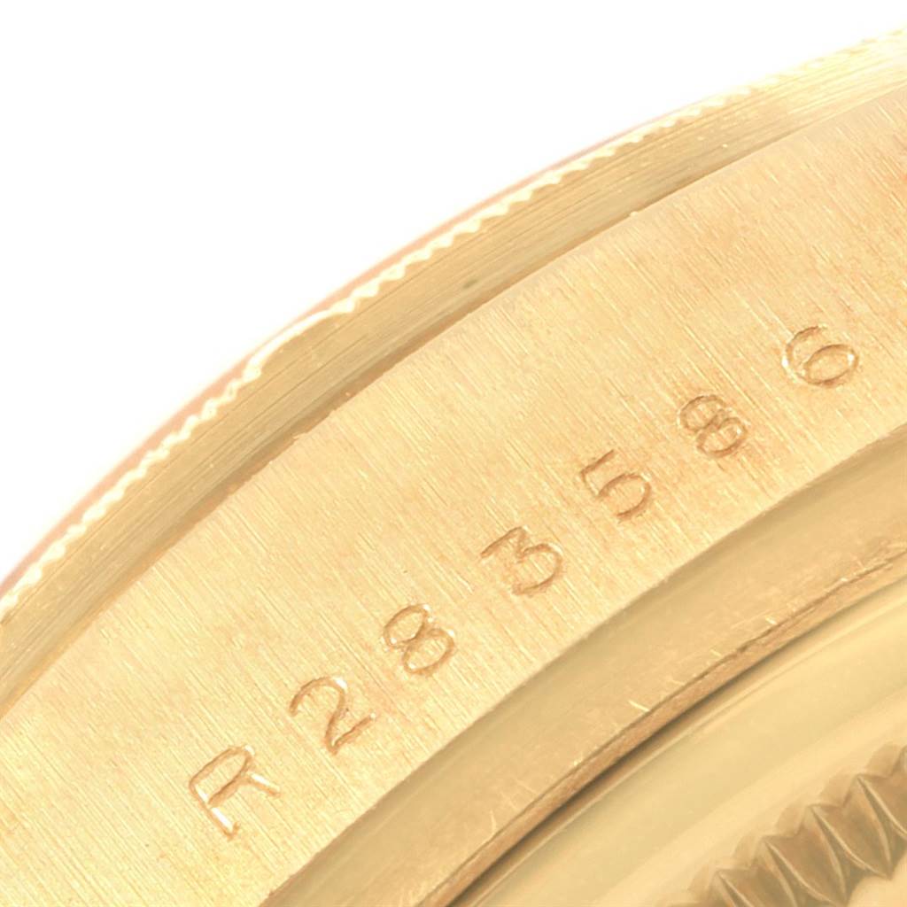 The image shows a close-up angle of the case side of a Rolex President 18078 Men's Yellow Gold Black Dial 18078 Men's Yellow Gold Black Dial model, highlighting the serial number engraving.