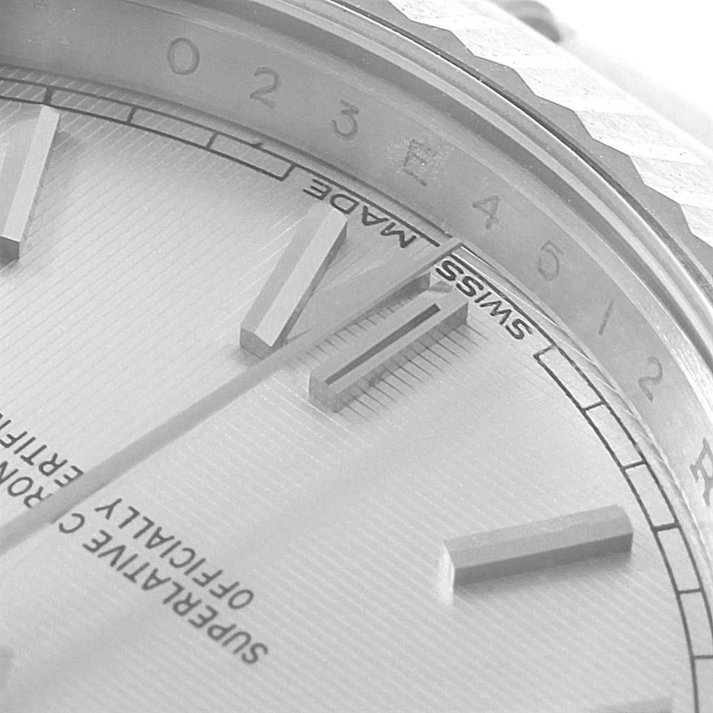 This close-up angle shows the dial, markers, and part of the fluted bezel of a Rolex President 228239 Men's White Gold Silver Dial 228239 Men's White Gold Silver Dial model watch.