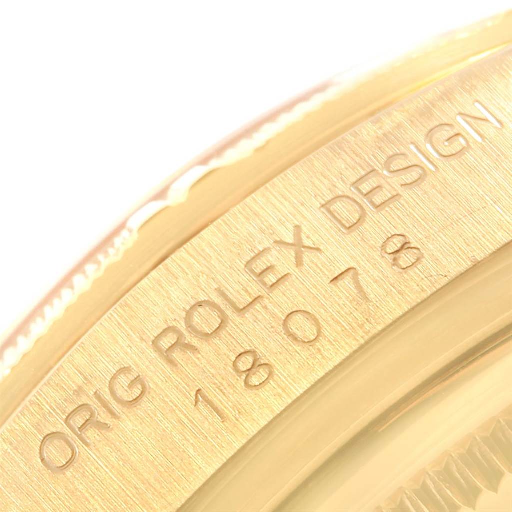 This image shows a close-up of the side of the Rolex President 18078 Men
s Yellow Gold Champagne Dial 18078 Men
s Yellow Gold Champagne Dial model, highlighting the engraving.