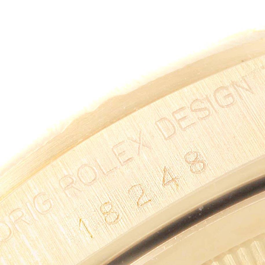 The image shows a close-up of the engraved bezel of a Rolex President 18248 Men
s Yellow Gold Champagne Dial 18248 Men
s Yellow Gold Champagne Dial model watch, highlighting the "ROLEX DESIGN" inscription and model number.