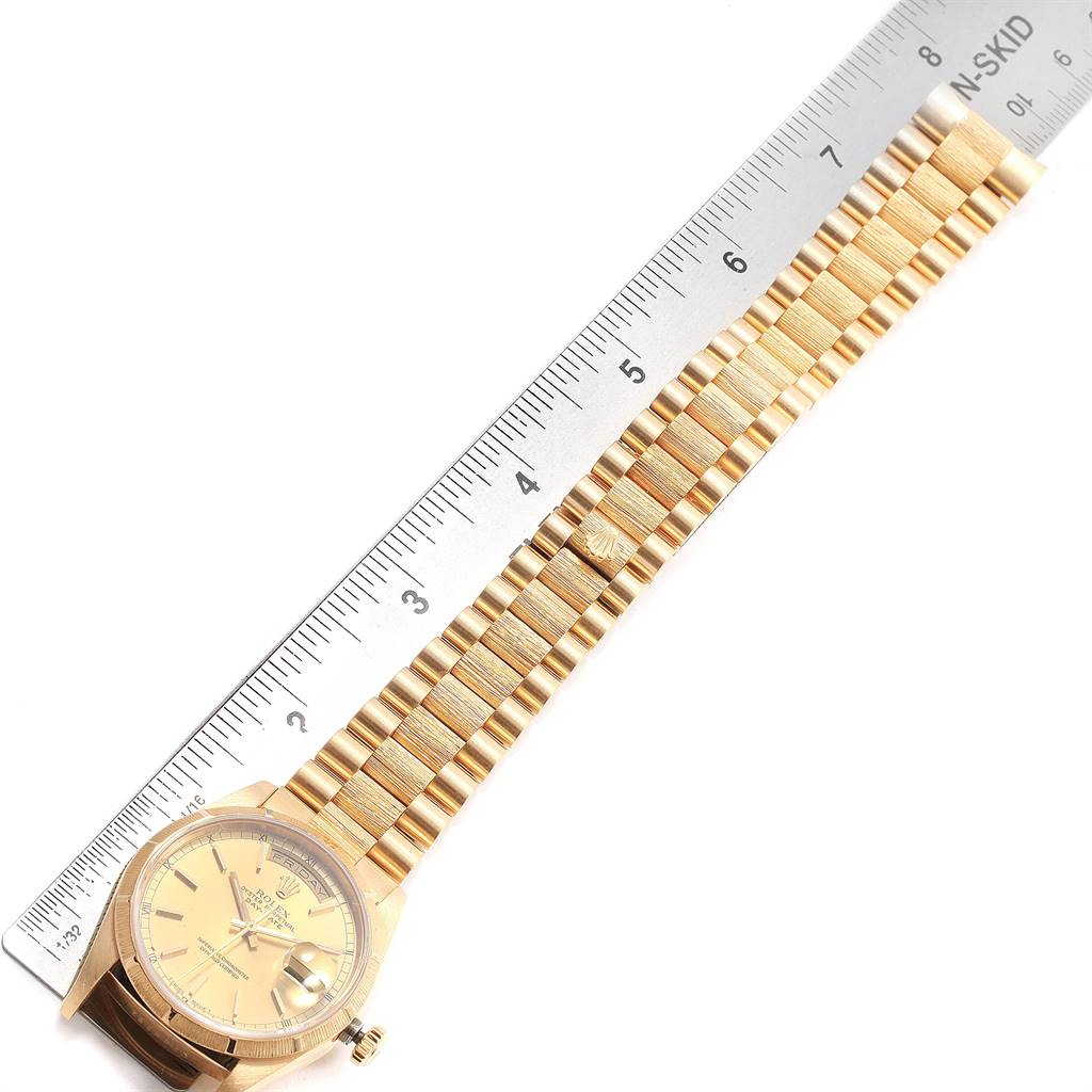 The image shows a Rolex President 18248 Men
s Yellow Gold Champagne Dial 18248 Men
s Yellow Gold Champagne Dial model watch laid flat beside a ruler for measurement.