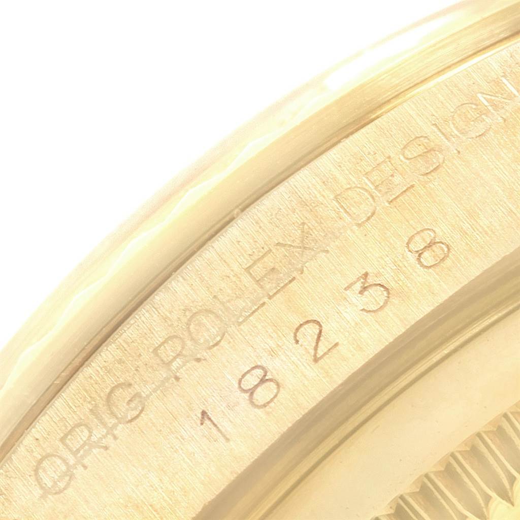 The image shows a close-up of the engraved side of the Rolex President 18238 Men
s Yellow Gold Black Dial 18238 Men
s Yellow Gold Black Dial watch model.