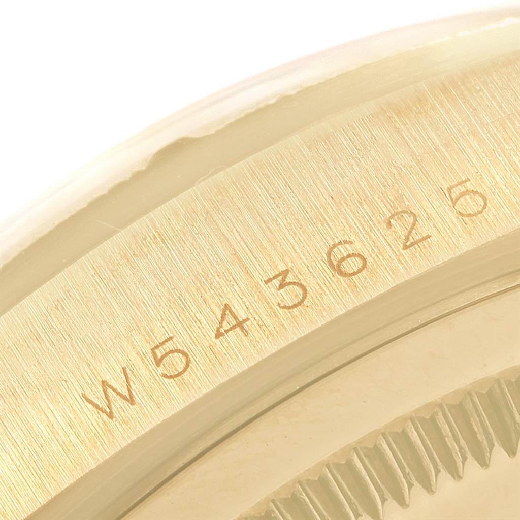 The image shows a close-up of the serial number engraved on the side of the bezel of a Rolex President 18308 Men
s Yellow Gold Black Dial 18308 Men
s Yellow Gold Black Dial model watch.