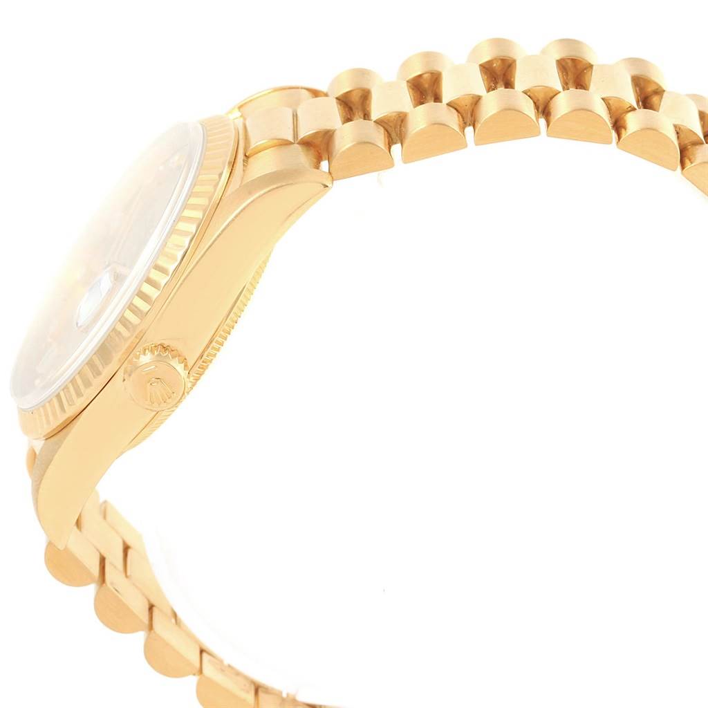 The image shows a side profile of the Rolex President 18238 Men's Yellow Gold Champagne Dial 18238 Men's Yellow Gold Champagne Dial watch, highlighting its case, crown, bezel, and part of the bracelet.