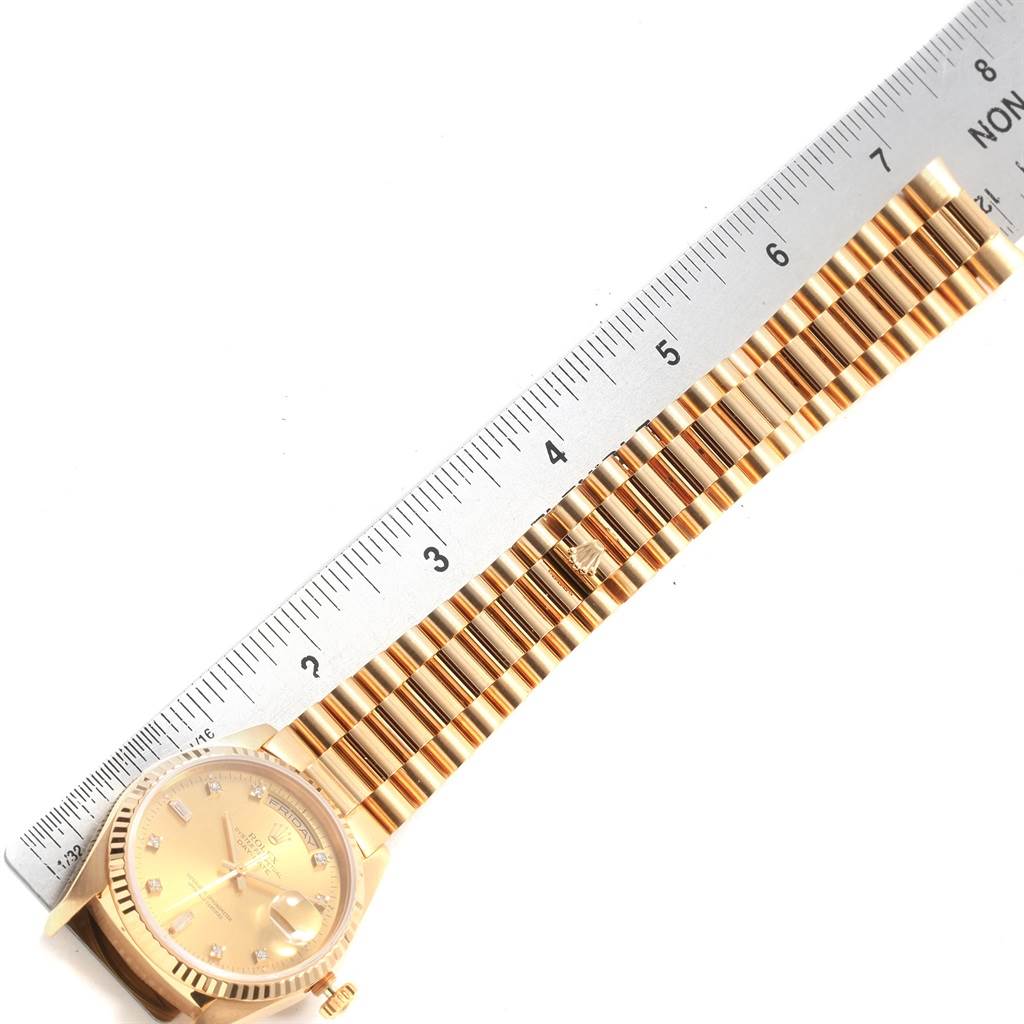 This image shows a Rolex President 18238 Men's Yellow Gold Champagne Dial 18238 Men's Yellow Gold Champagne Dial model watch placed at an angle, highlighting the dial, bracelet, and a ruler for measurement.