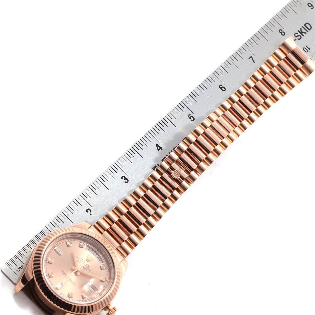 The image shows the face and bracelet of a Rolex President 218235 Men's Rose Gold Pink Dial 218235 Men's Rose Gold Pink Dial model watch, with a ruler beside it for scale.