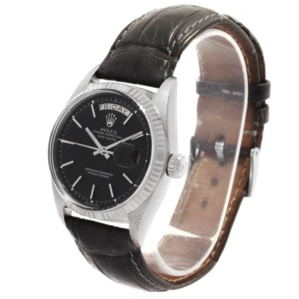 The image shows a Rolex President 1803 Men
s White Gold Black Dial 1803 Men
s White Gold Black Dial model watch at a three-quarter angle, highlighting its black dial, leather strap, and day-date window.