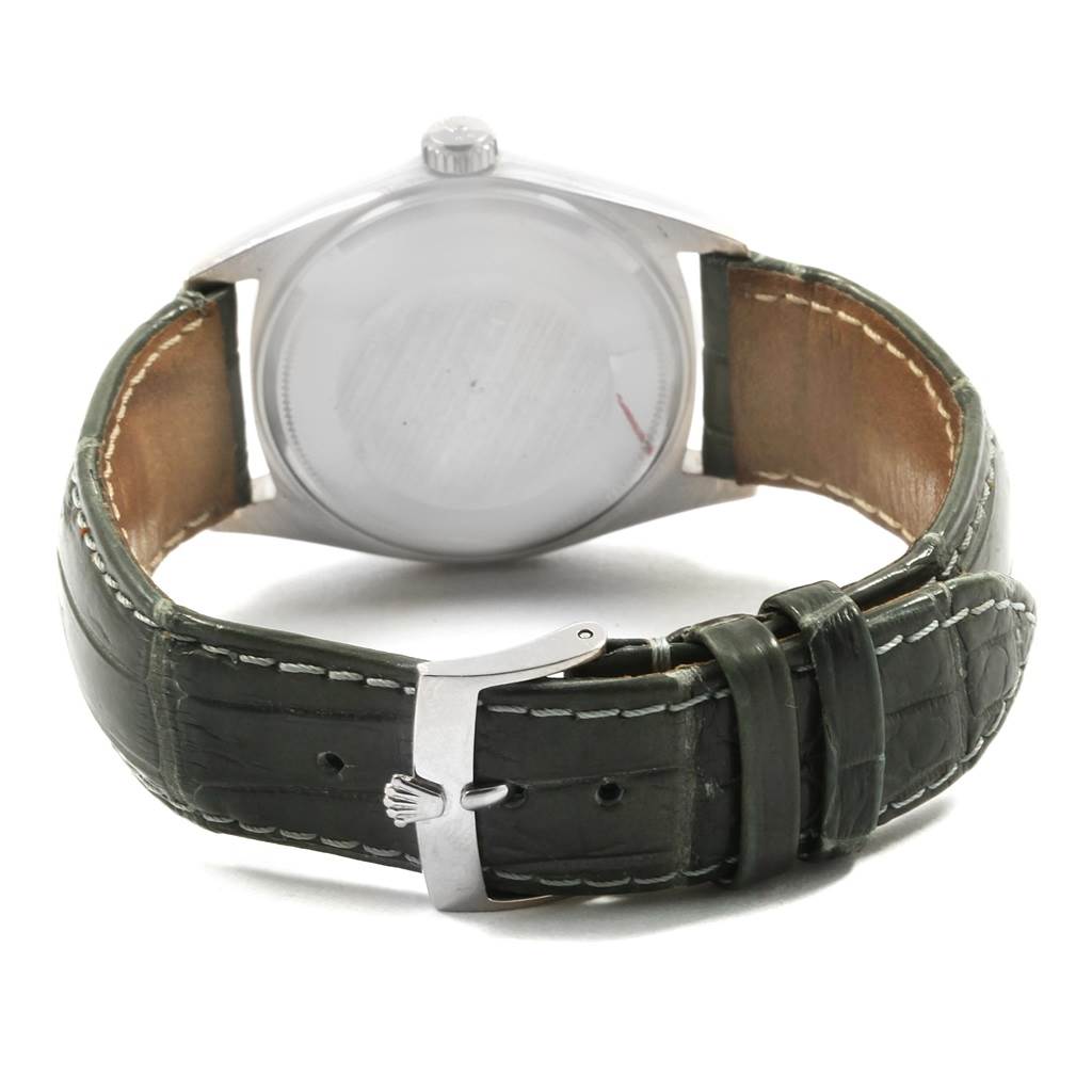 The image shows the back of a Rolex President 1803 Men
s White Gold Black Dial 1803 Men
s White Gold Black Dial model watch with its leather strap and clasp.