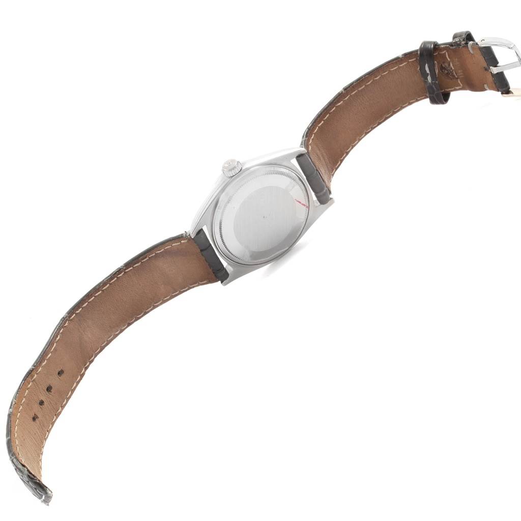 The image shows the back view of a Rolex President 1803 Men
s White Gold Black Dial 1803 Men
s White Gold Black Dial model watch with its leather strap fully extended.