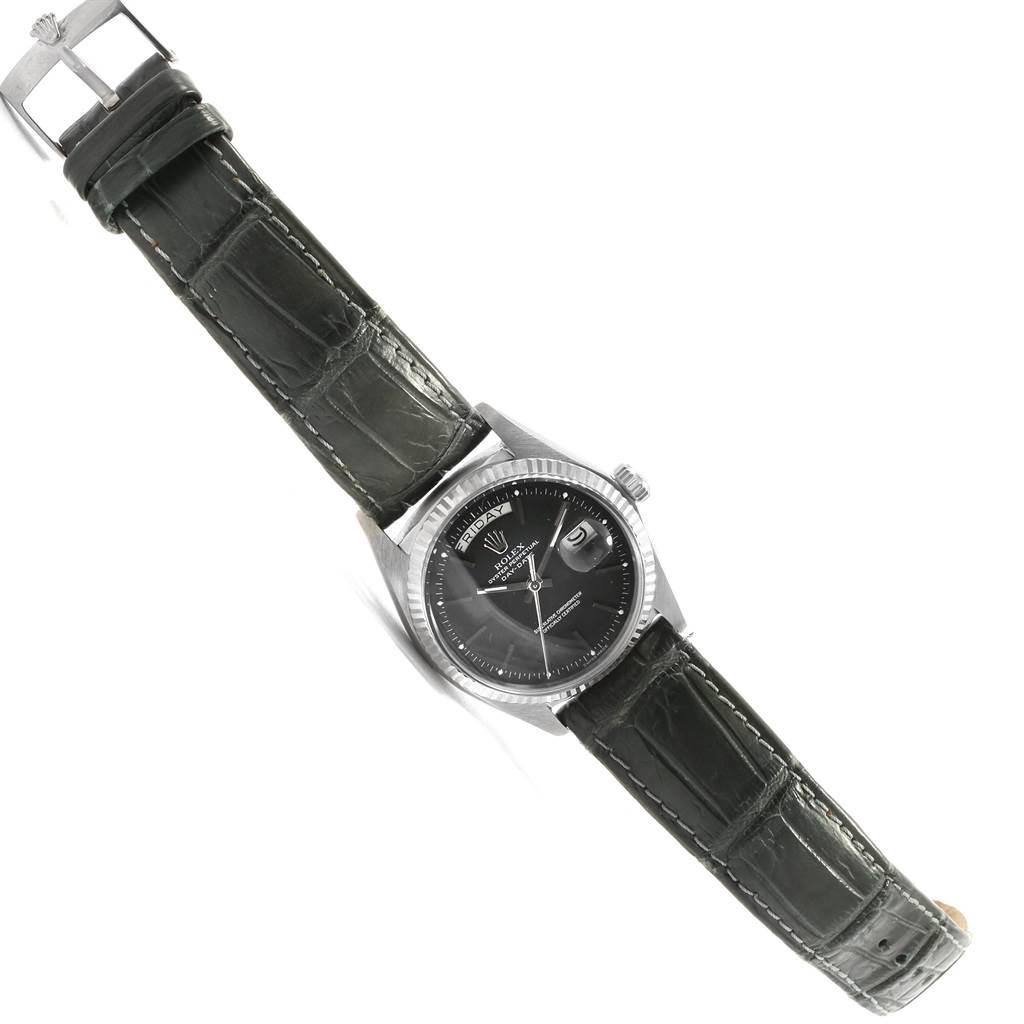 The image shows a top-down view of a Rolex President 1803 Men
s White Gold Black Dial 1803 Men
s White Gold Black Dial model watch featuring its black dial and green leather strap.