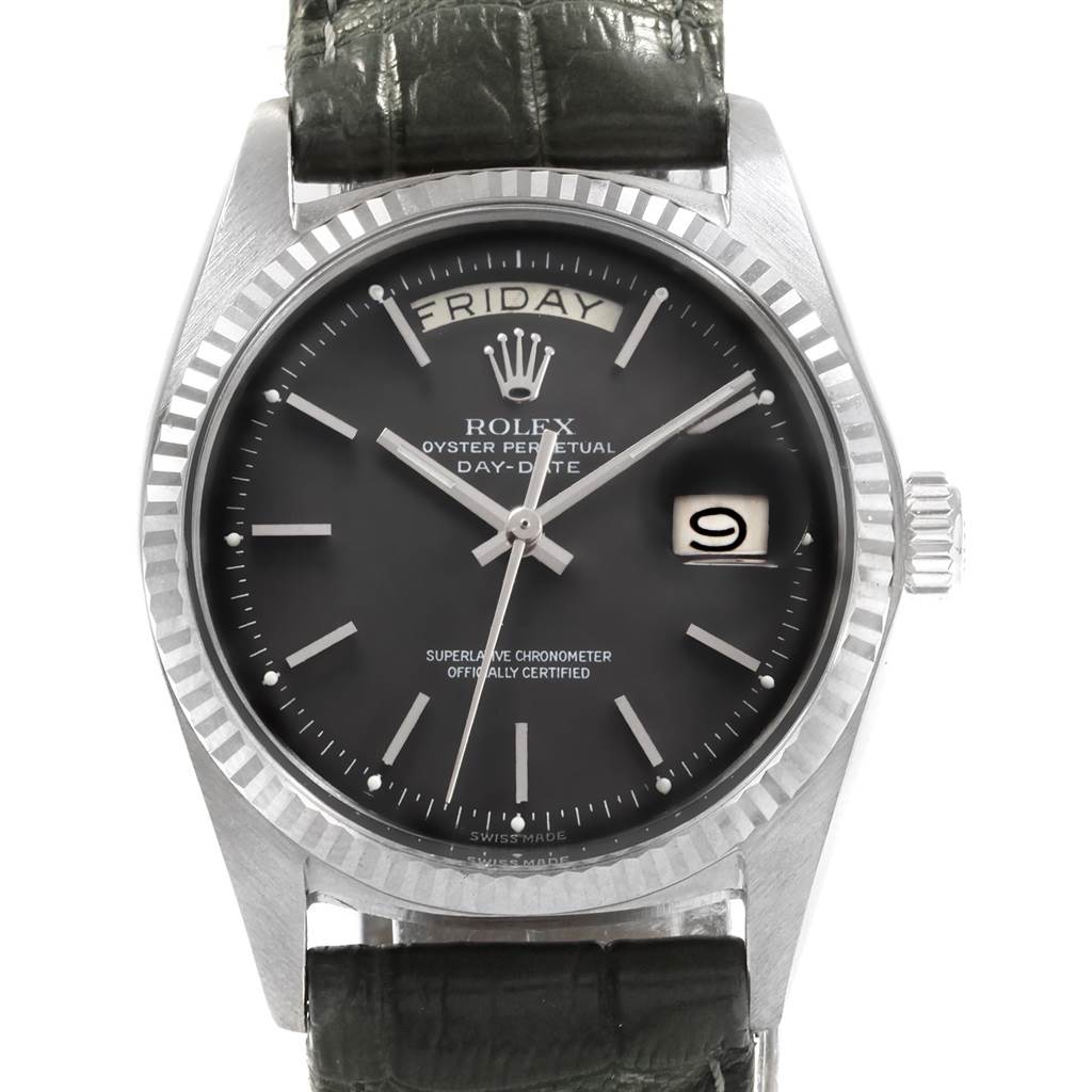 The Rolex President 1803 Men
s White Gold Black Dial 1803 Men
s White Gold Black Dial watch is shown from a straight-on angle, displaying the face, day and date indicators, bezel, and part of the strap.
