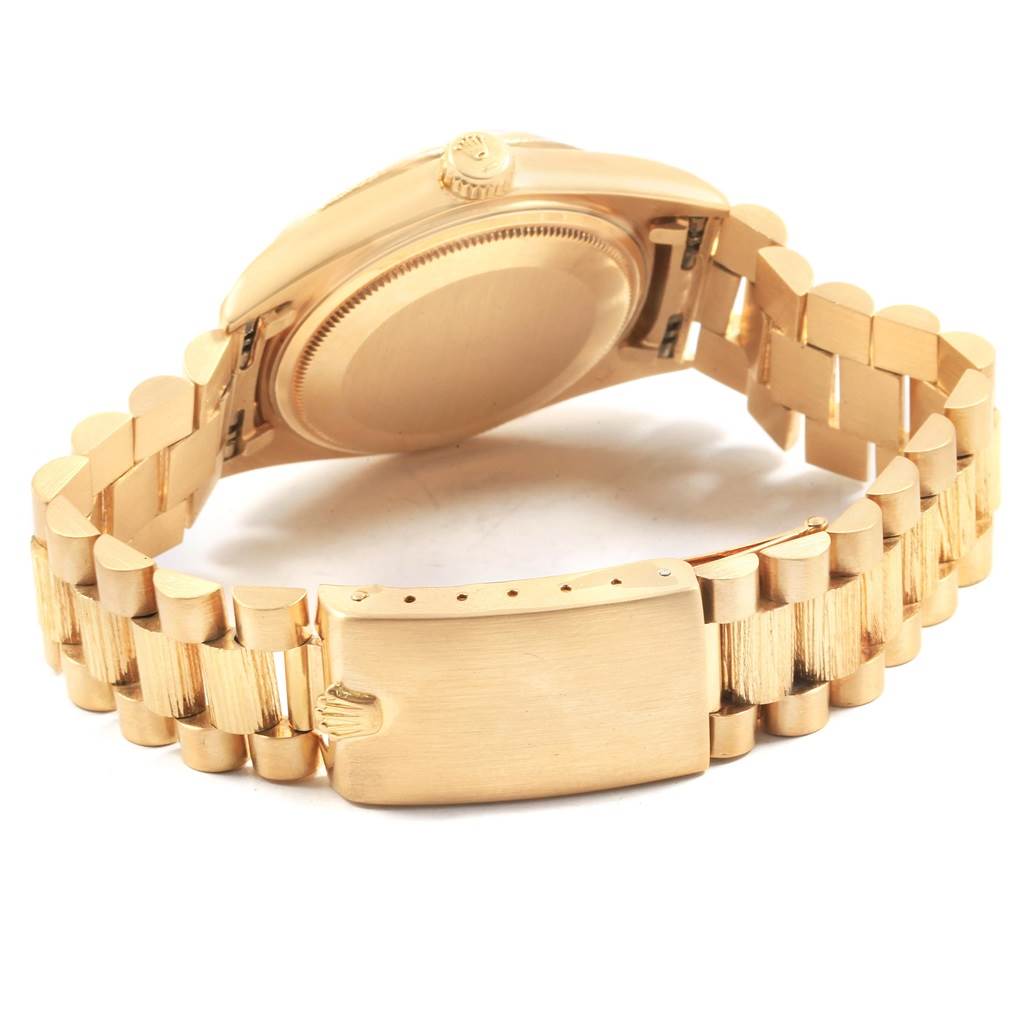 The image shows the back view of a Rolex President 1807 Men's Yellow Gold Champagne Dial 1807 Men's Yellow Gold Champagne Dial model watch, highlighting its case back, crown, and President bracelet.