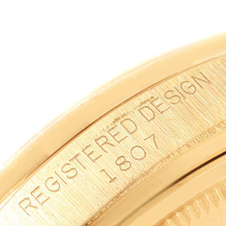 The image shows a close-up of the side casing of the Rolex President 1807 Men's Yellow Gold Champagne Dial 1807 Men's Yellow Gold Champagne Dial model watch, featuring engraved text.