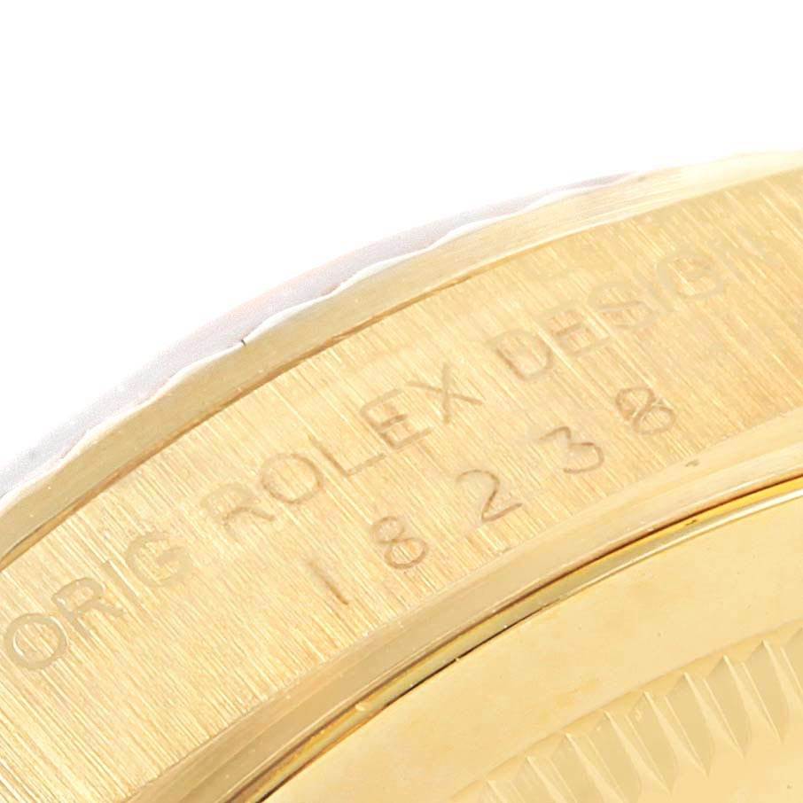 The image shows a close-up of the engraved case side of a Rolex President 18238 Men
s Yellow Gold Champagne Dial 18238 Men
s Yellow Gold Champagne Dial model.
