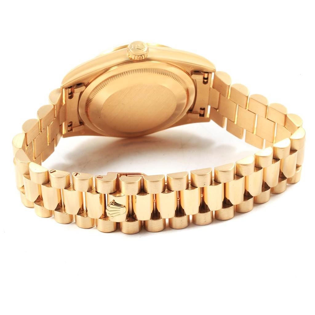 This image shows the back case and bracelet of the Rolex President 18238 Men
s Yellow Gold Champagne Dial 18238 Men
s Yellow Gold Champagne Dial model watch from a slightly low side angle.