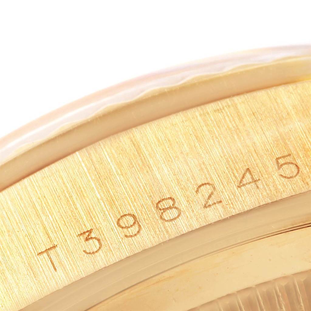 The image shows a close-up of the engraved serial number on the side of a Rolex President 18238 Men
s Yellow Gold Champagne Dial 18238 Men
s Yellow Gold Champagne Dial model watch.