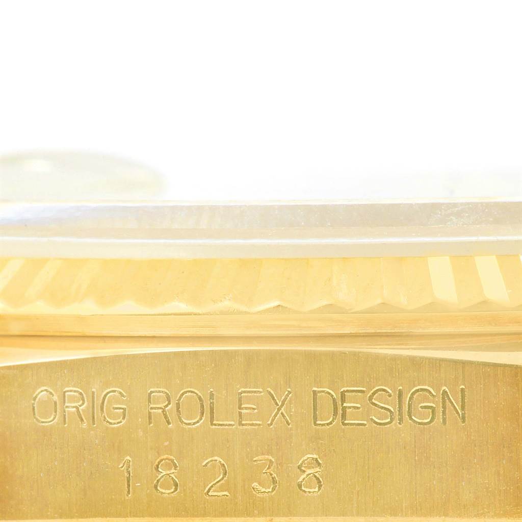 This close-up image shows the engraved case and the fluted bezel of a Rolex President 18238 Men's Yellow Gold White Dial 18238 Men's Yellow Gold White Dial model watch.