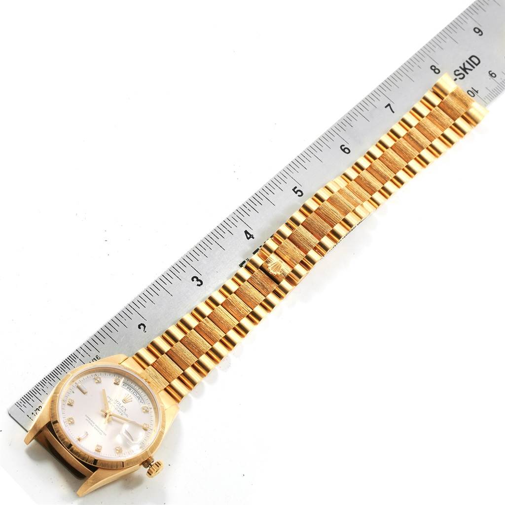 The image shows a gold Rolex President 18248 Men's Yellow Gold Silver Dial 18248 Men's Yellow Gold Silver Dial model watch laid flat next to a ruler, displaying the watch face and bracelet.