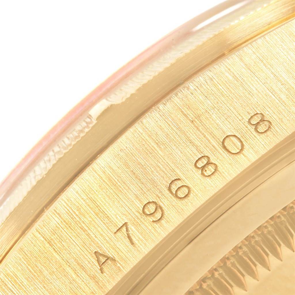 This close-up image of the Rolex President 18248 Men
s Yellow Gold Champagne Dial 18248 Men
s Yellow Gold Champagne Dial watch shows its engraved serial number on the gold case.