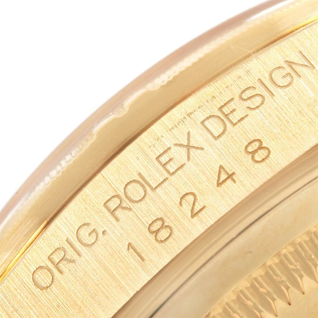 This image shows a close-up of the model number and "ORIG. ROLEX DESIGN" engraving on the case of a Rolex President 18248 Men
s Yellow Gold Champagne Dial 18248 Men
s Yellow Gold Champagne Dial watch.