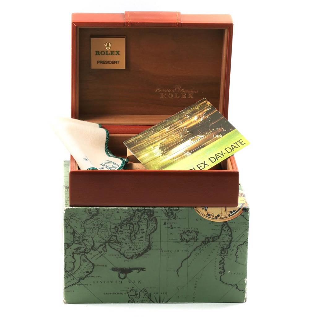 The image shows a Rolex President 18248 Men
s Yellow Gold Champagne Dial 18248 Men
s Yellow Gold Champagne Dial model watch box, including a cleaning cloth and a booklet, photographed at a front angle.