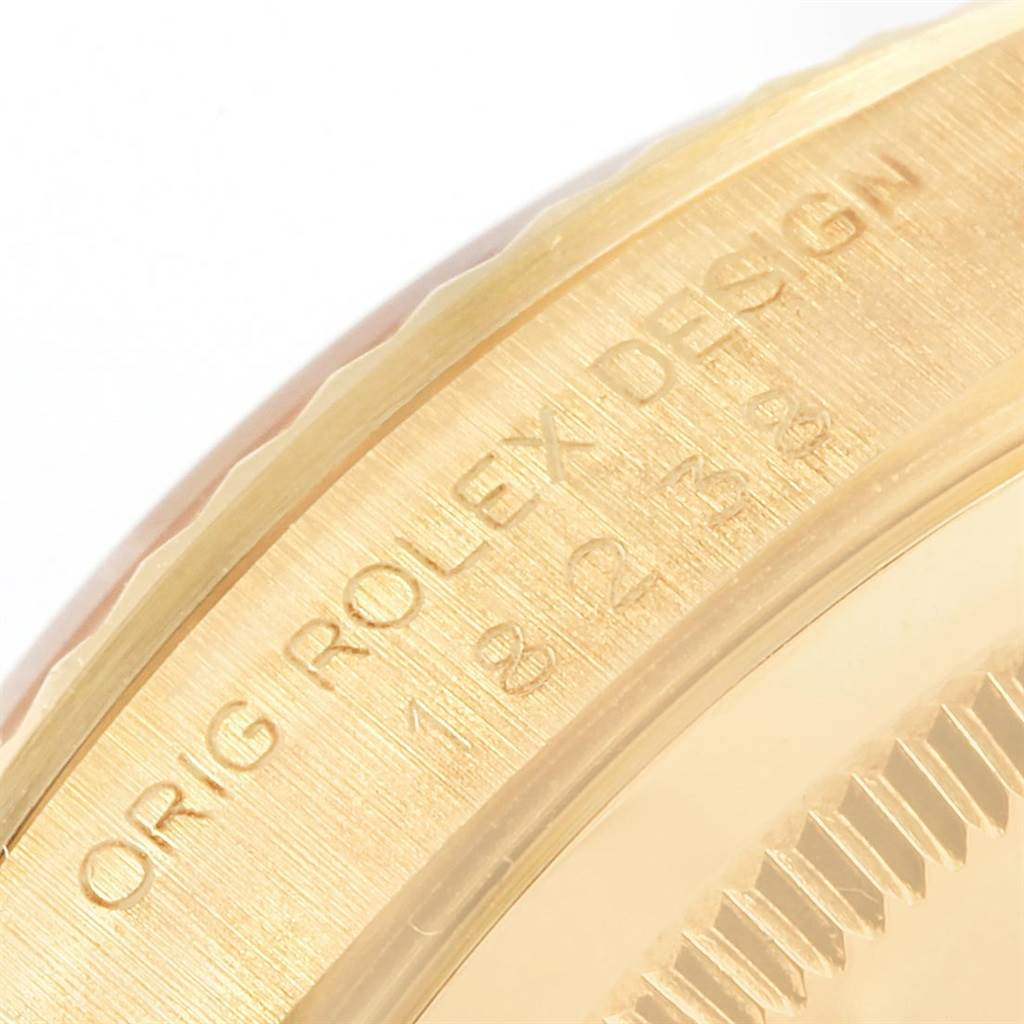 This close-up image shows the engraved side of a Rolex President 18238 Men
s Yellow Gold Champagne Dial 18238 Men
s Yellow Gold Champagne Dial model watch bezel.