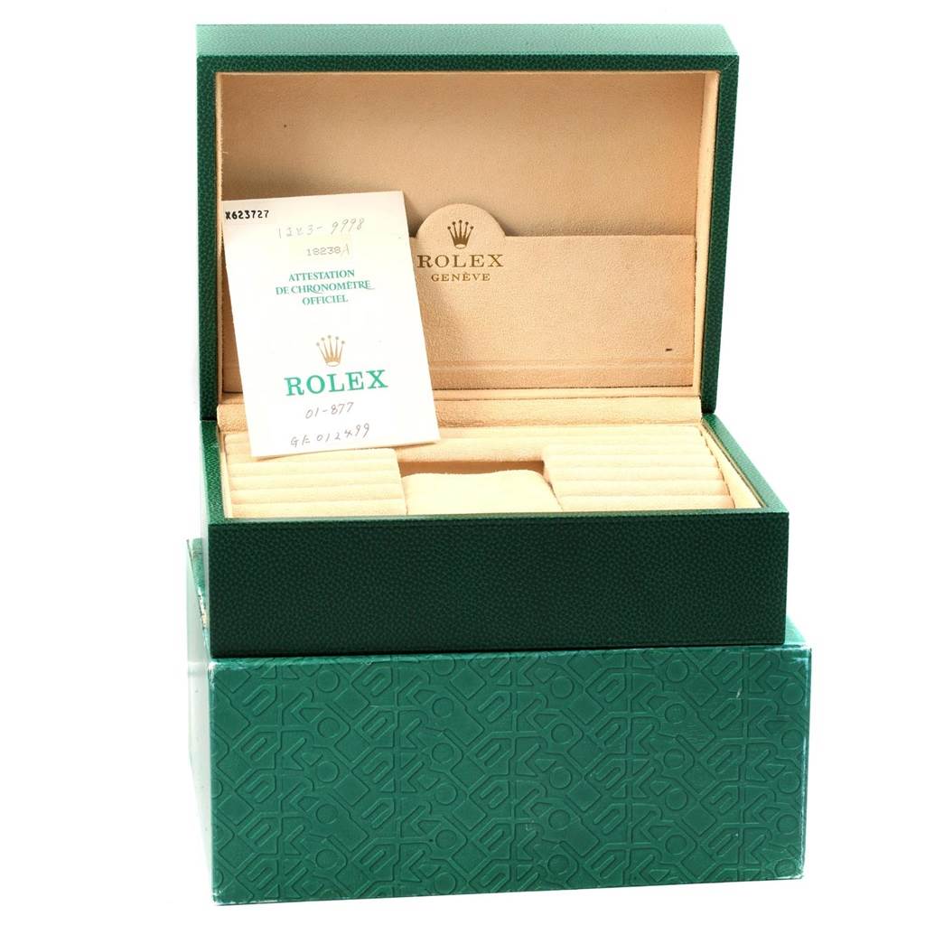 This image shows an open Rolex President 18238 Men
s Yellow Gold Champagne Dial 18238 Men
s Yellow Gold Champagne Dial model box with a certification card placed inside.