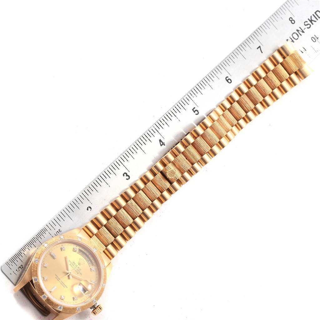 The image shows a Rolex President 18108 Men
s Yellow Gold Champagne Dial 18108 Men
s Yellow Gold Champagne Dial model watch laid flat, displaying the face, bezel, and full bracelet against a ruler.