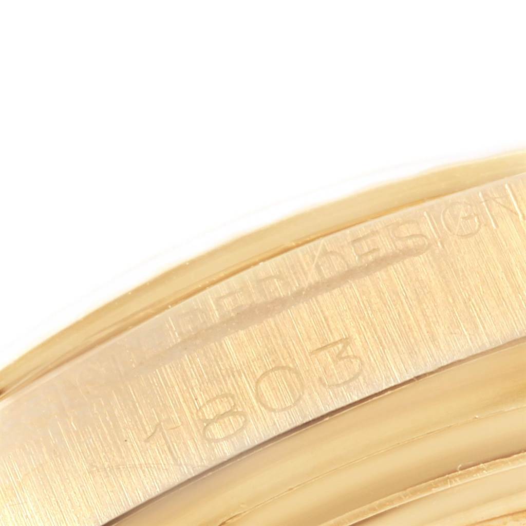 The image shows a close-up of the engraved serial number on the case back of a Rolex President 1803 Men
s Yellow Gold Champagne Dial 1803 Men
s Yellow Gold Champagne Dial model watch.