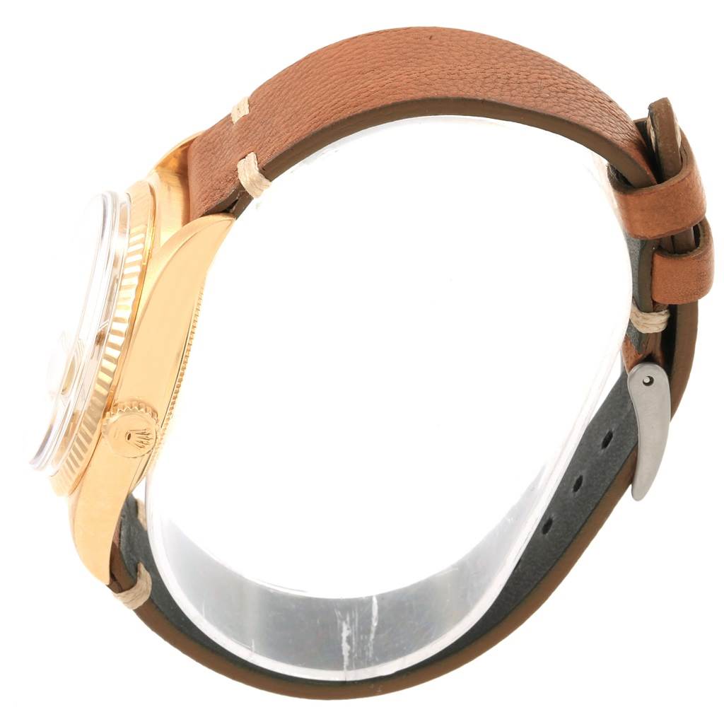The image shows a side view of the Rolex President 1803 Men
s Yellow Gold Champagne Dial 1803 Men
s Yellow Gold Champagne Dial model watch with its gold case, crown, and brown leather strap.